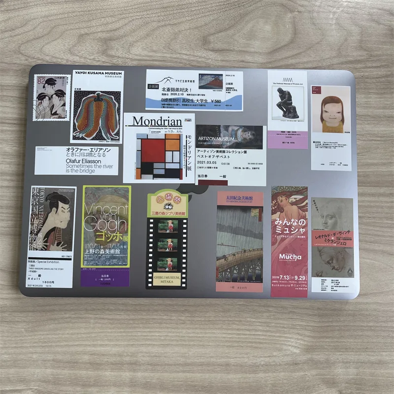 Board covered with museum-poster fridge magnets of different sizes