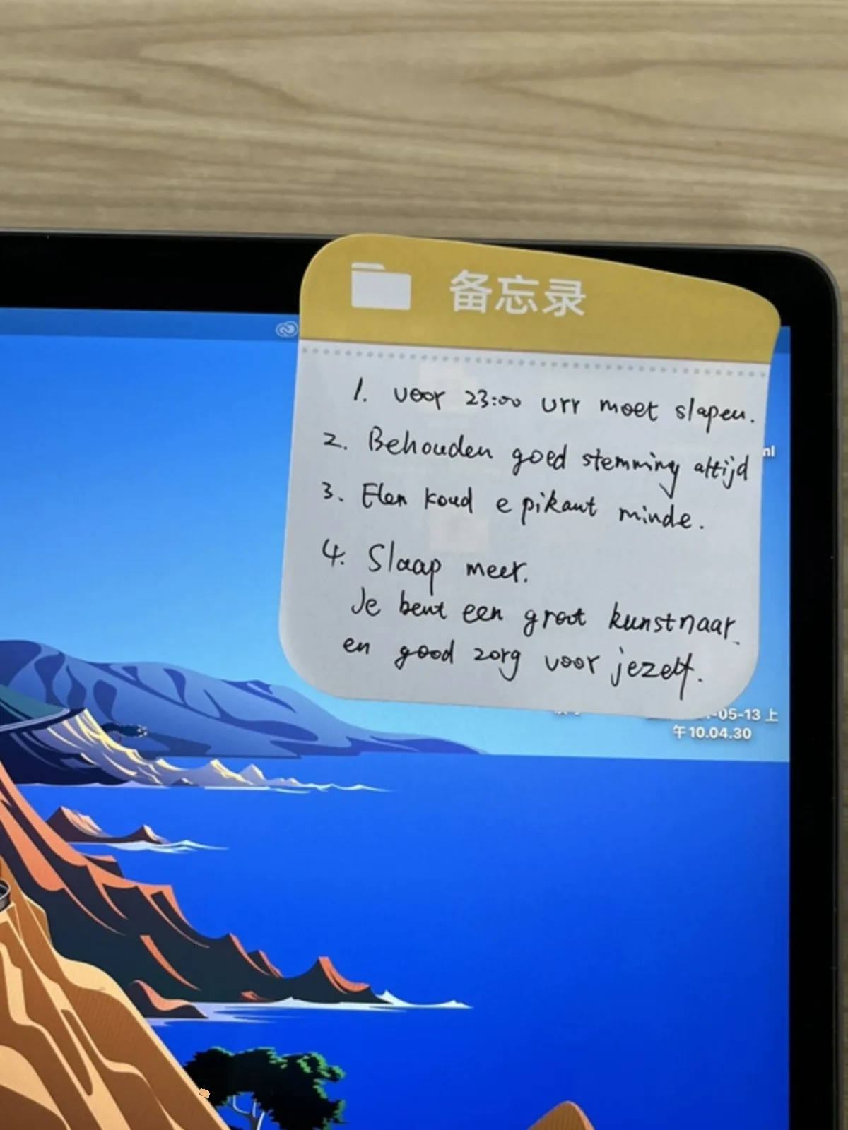 Sticky note with handwriting stuck to a tablet screen, in use